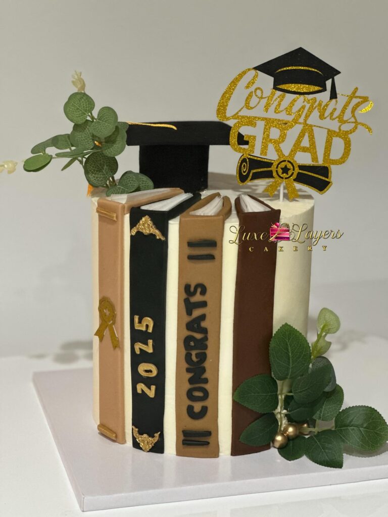 Custom vanilla graduation cake with books design Miami — Luxe Layers Cakery