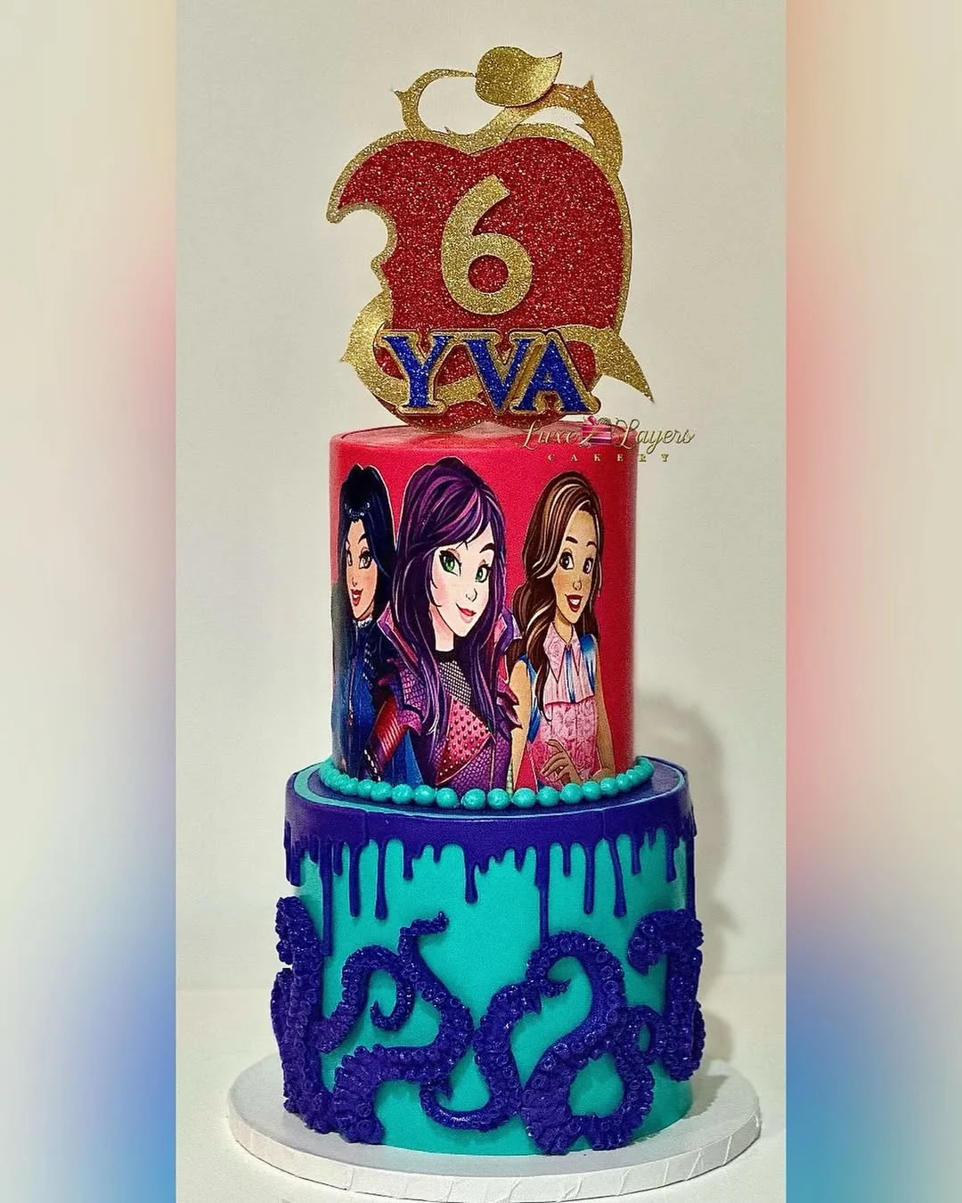 Red, purple, teal, and blue Disney Descendants 6th birthday tiered cake with character wrap, drip effect, scroll piping, and custom glitter apple topper — kids birthday cakes Miami by Luxe Layers Cakery
