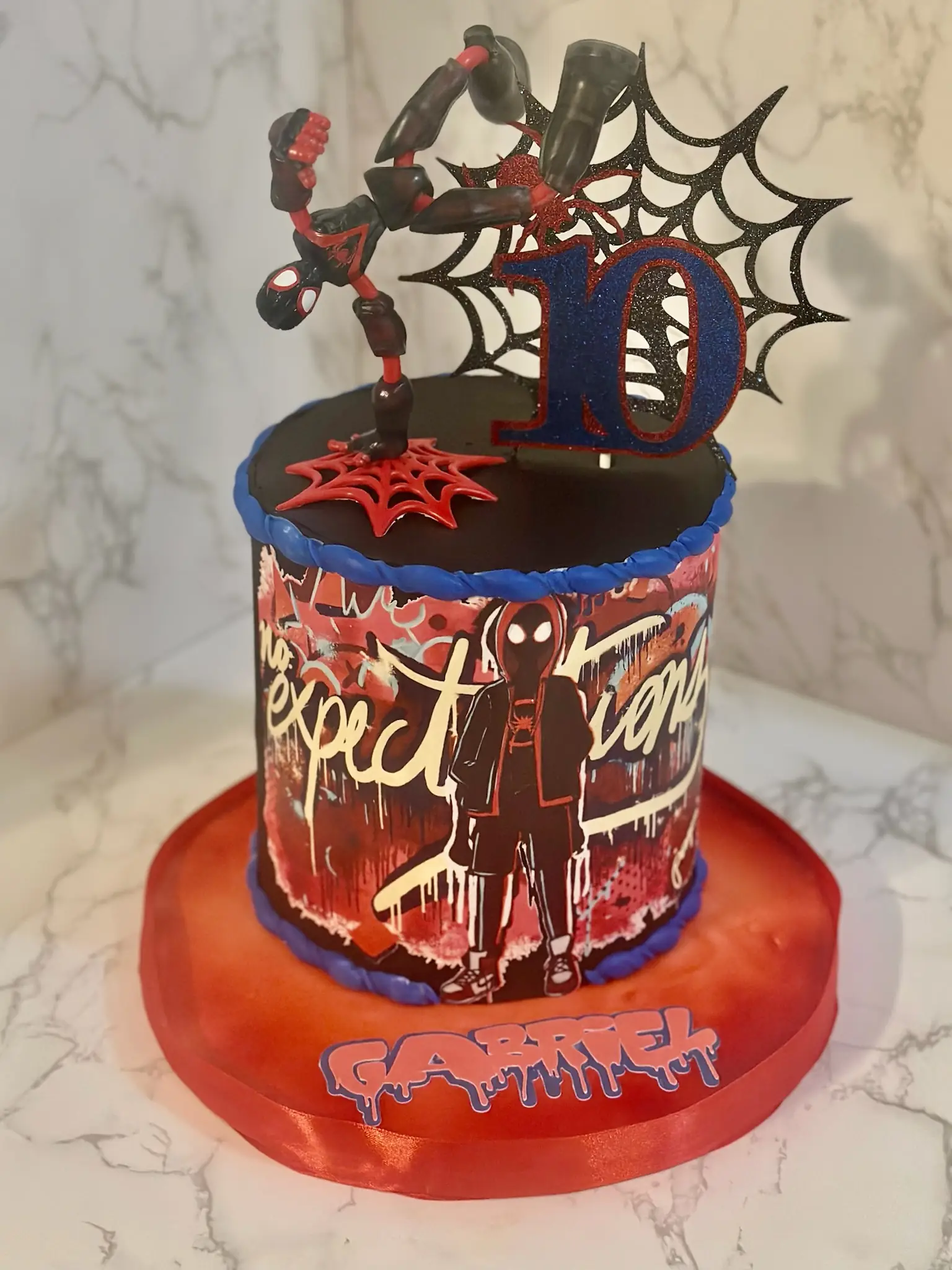 Red and black Spiderman Miles Morales 10th birthday cake with spider web design and fondant details — kids birthday cakes Miami by Luxe Layers Cakery