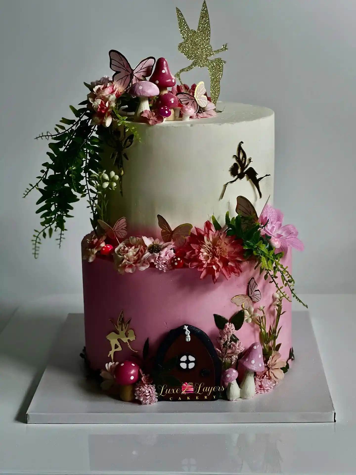 Strawberry pink and white fairy garden birthday cake Miami with butterfly and floral details by Luxe Layers Cakery