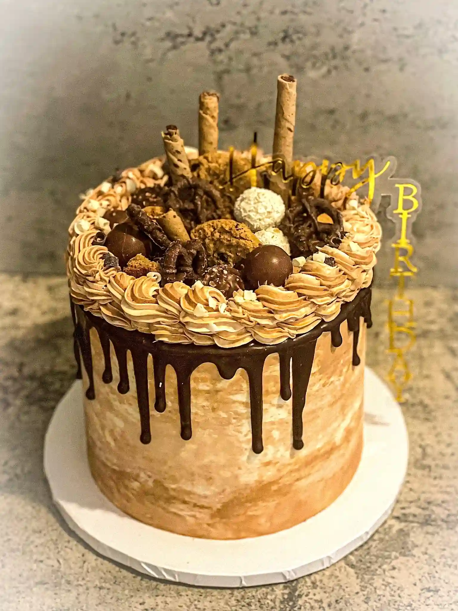 Custom chocolate drip birthday cake Miami loaded with candy and chocolate truffles by Luxe Layers Cakery