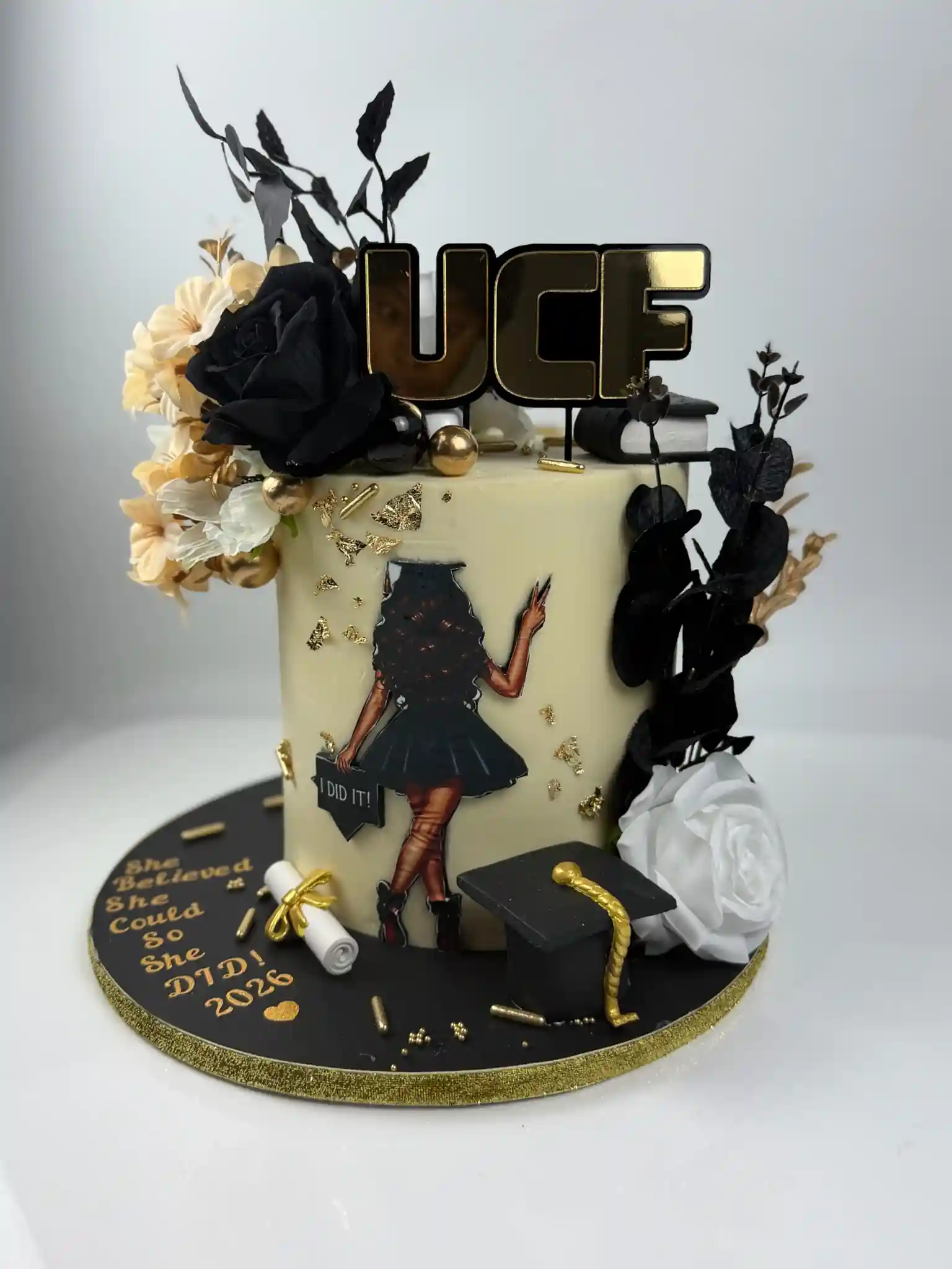Hallandale Beach cake Miami design black and gold graduation cake with floral accents Luxe Layers Cakery