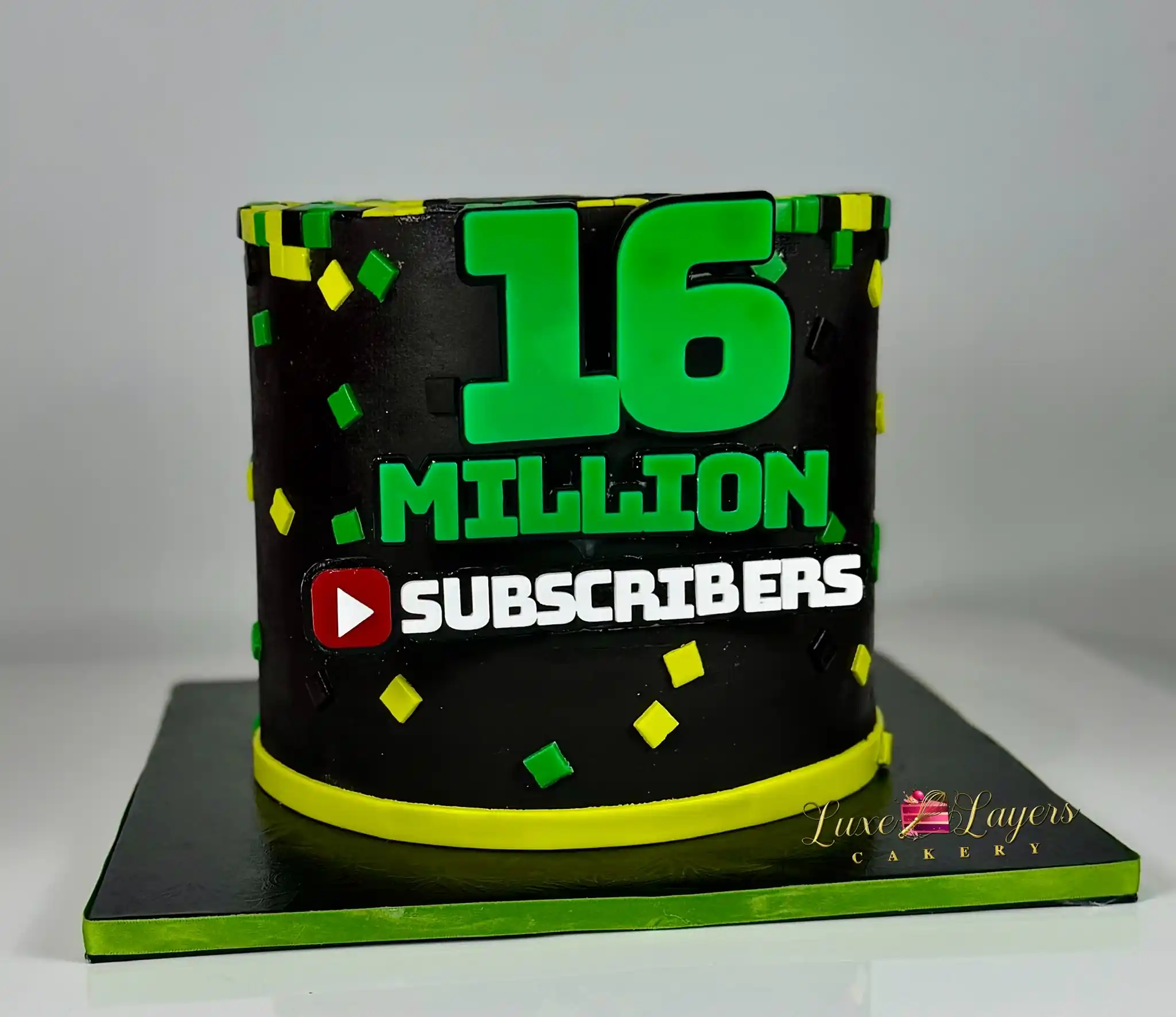 Custom blocky pixel-art cake celebrating Kai Cenat's 16 million YouTube subscriber milestone, black and green fondant design on a custom cake board, by Luxe Layers Cakery Miami.